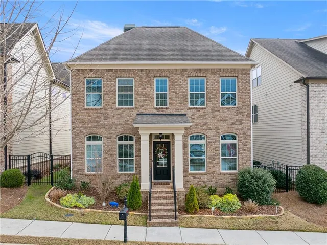 a front view of a house with garden
