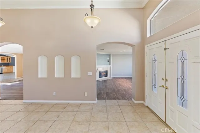 a view of a livingroom with a fireplace wooden floor and chandelier