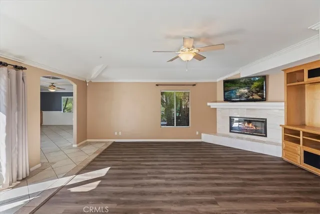 a view of a room with a ceiling fan and window