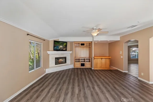 a kitchen with stainless steel appliances granite countertop a stove a refrigerator a sink and a microwave oven with large wooden floor