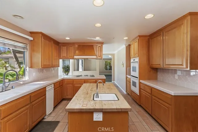 a view of a hallway with wooden floor and a living room
