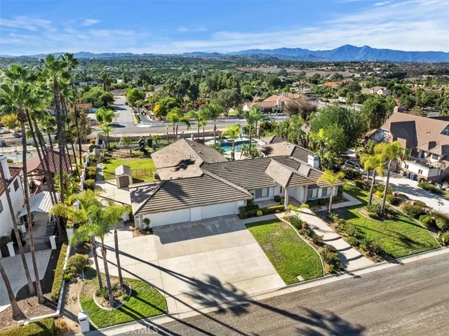 an aerial view of a house with swimming pool garden and patio