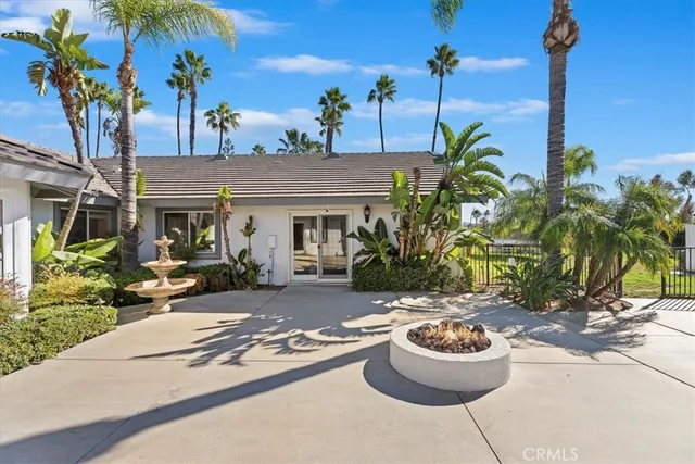 a view of a house with a backyard and a tree