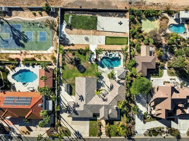 a front view of a house with a yard and potted plants