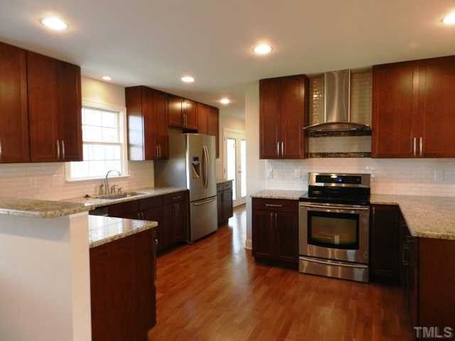 5308 Fairoaks Road Durham, NC 27712 - Photo 2 of 4 Granite counters, tile backsplash, new cabinets and appliances. You'll enjoy creating meals in this kitchen - lots of prep space and plenty of cabinets for storage.