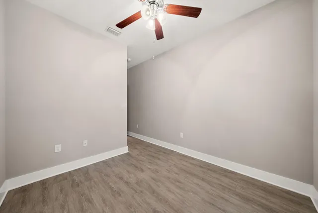 a view of spacious bathroom with a large mirror