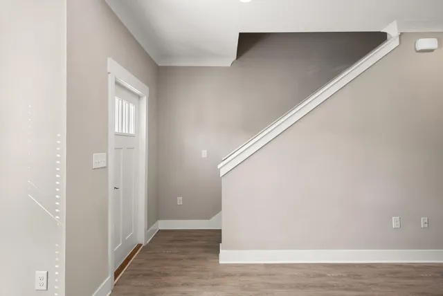 a view of an empty room with wooden floor