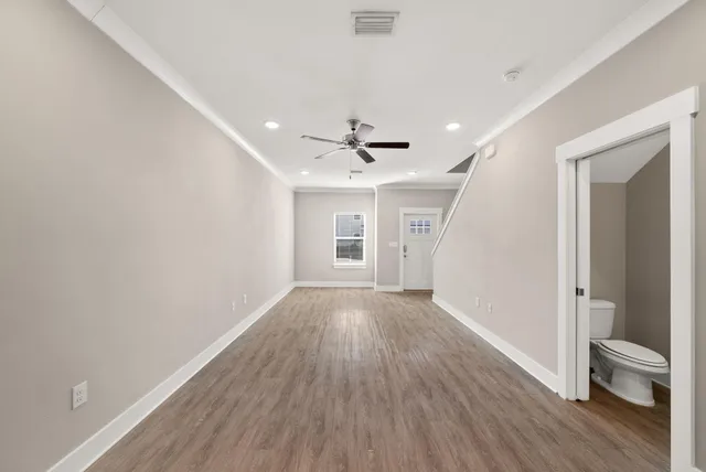 wooden floor in an empty room with a window