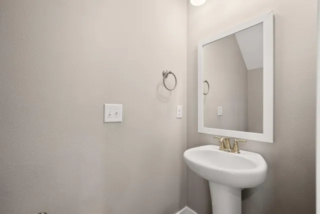 a kitchen with kitchen island a refrigerator sink and cabinets