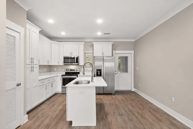 a kitchen with a sink and a refrigerator