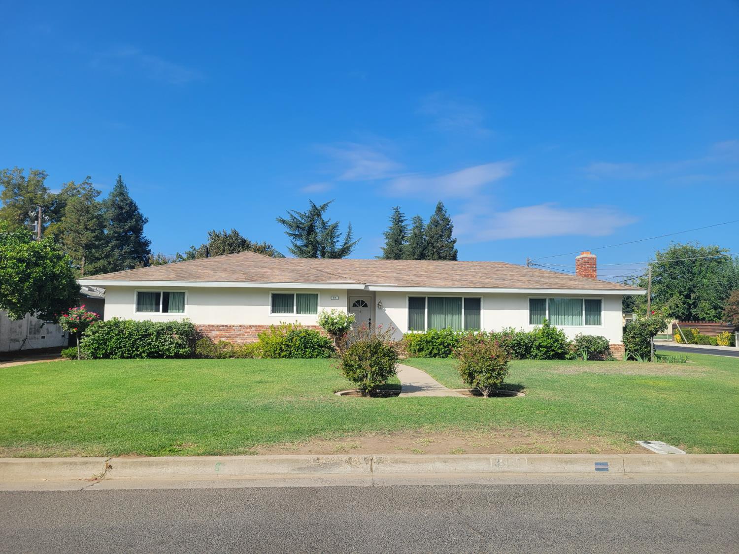 318 Williams Madera, CA 93637 - Photo 2 of 25 a front view of a house with a garden