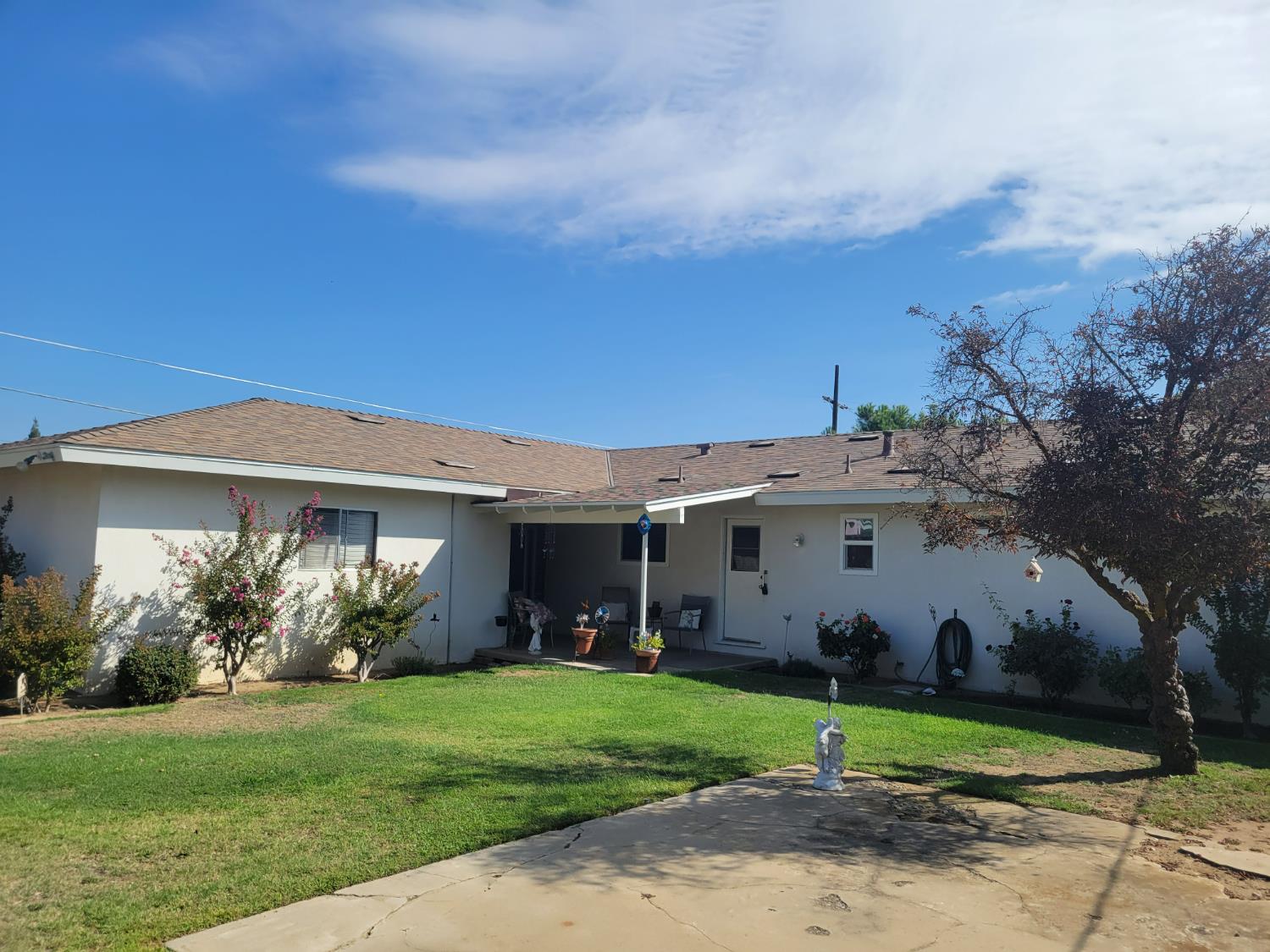318 Williams Madera, CA 93637 - Photo 22 of 25 a view of a white house in front of a yard with potted plants