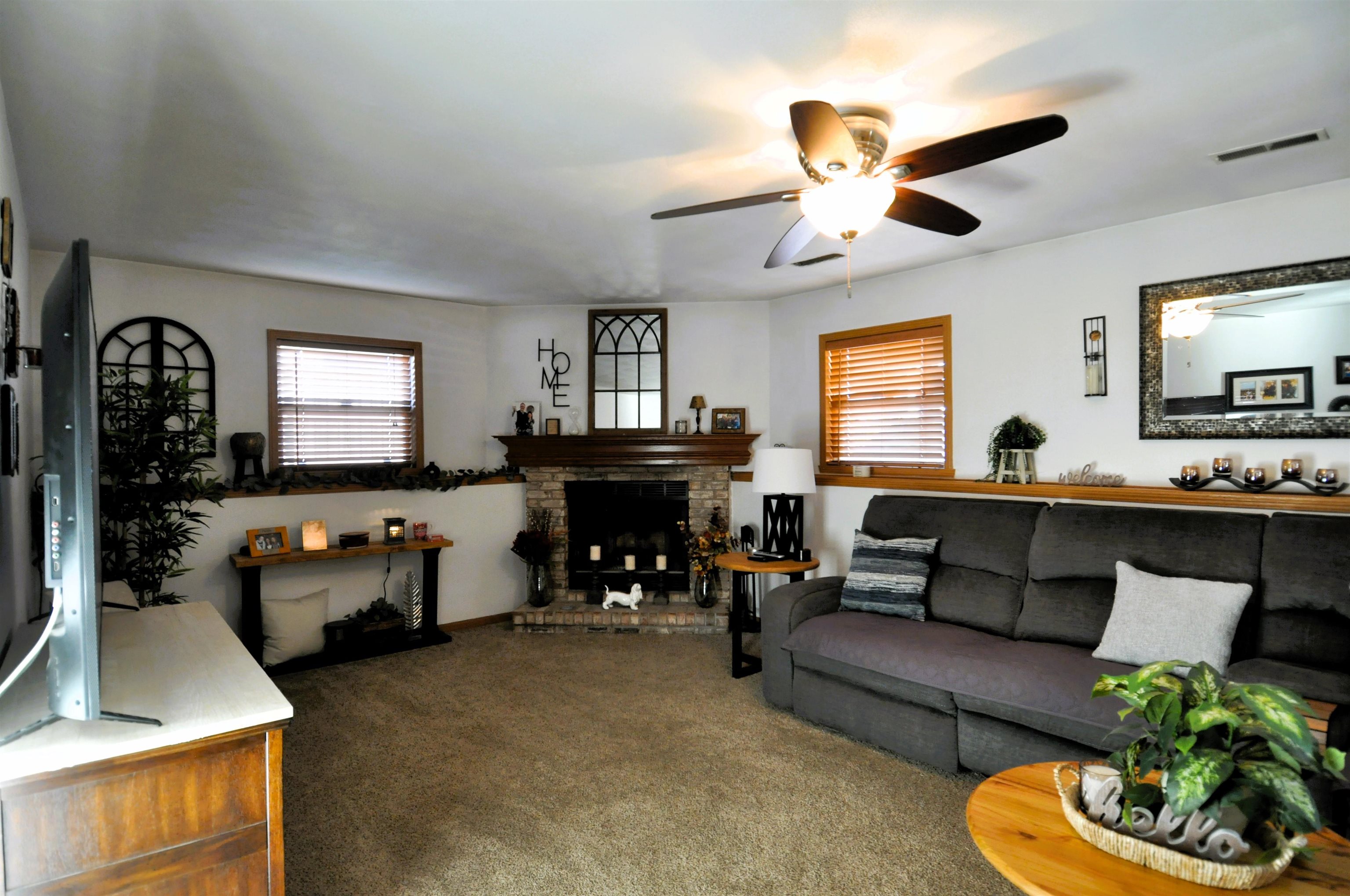 518 Merilot Drive Roscoe, IL 61073 - Photo 11 of 26 a living room with furniture a chandelier and a fireplace
