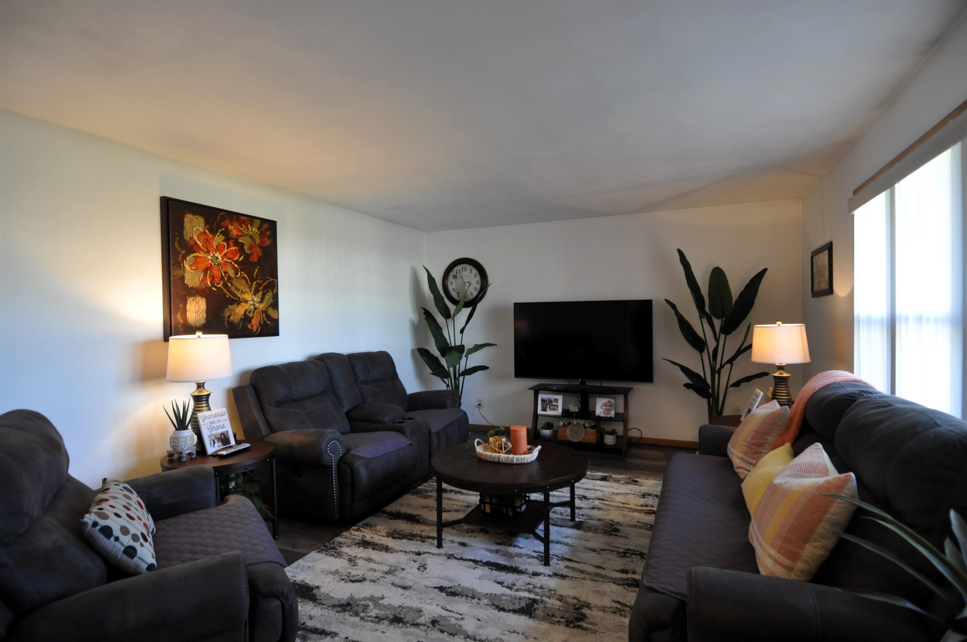 518 Merilot Drive Roscoe, IL 61073 - Photo 3 of 26 a living room with furniture a rug a lamp and a large window