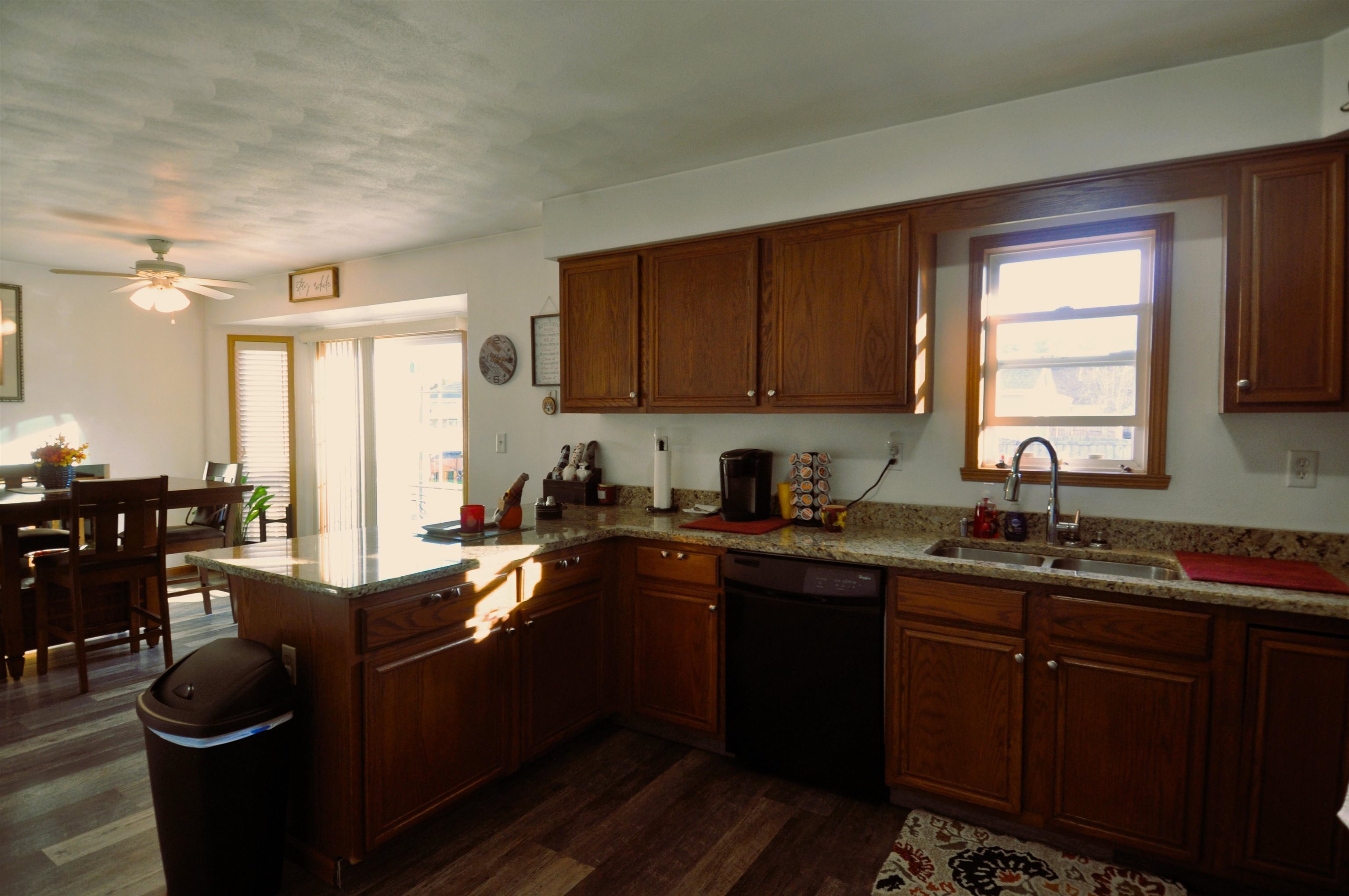 518 Merilot Drive Roscoe, IL 61073 - Photo 8 of 26 a kitchen with granite countertop a sink dishwasher stove and cabinets