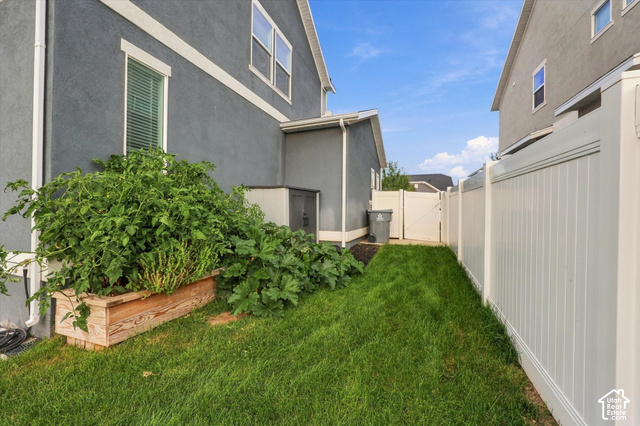 972 Vine Street Mapleton, UT 84664 - Photo 39 of 40 Manicured lawn with a privacy fence and a raised garden bed