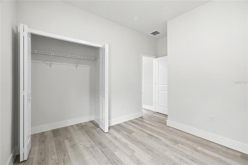 16082 Southwest 35th Court Road Ocala, FL 34473 - Photo 25 of 32 a view of an empty room with wooden floor and a window
