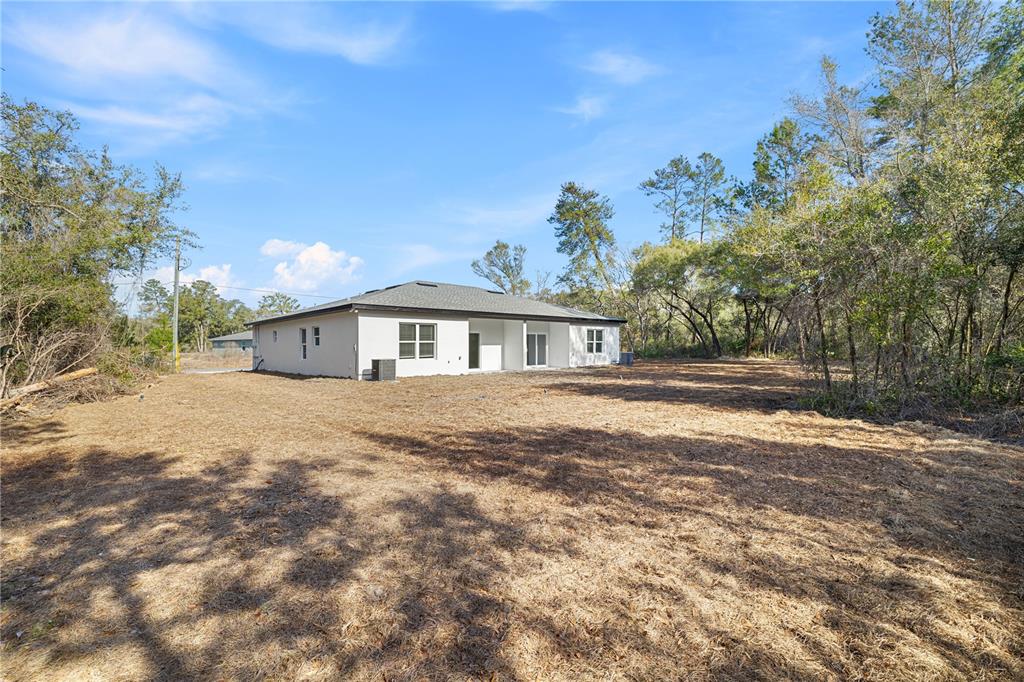 16082 Southwest 35th Court Road Ocala, FL 34473 - Photo 4 of 32 a front view of a house with a yard
