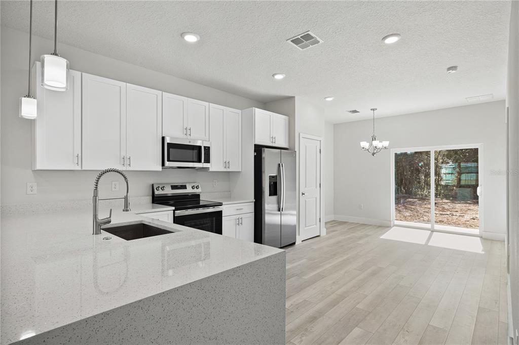 16082 Southwest 35th Court Road Ocala, FL 34473 - Photo 10 of 32 a kitchen with stainless steel appliances a refrigerator sink and microwave