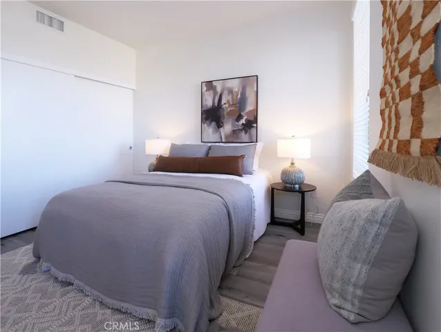 a bedroom with a bed and a lamp