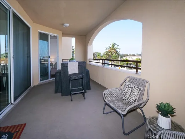 a view of a workspace with furniture and a potted plant