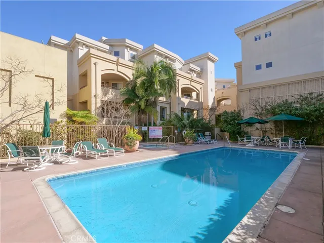 a swimming pool with outdoor seating and yard