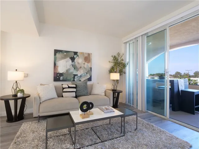 a living room with furniture a large mirror and a table