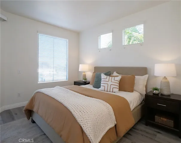 a bedroom with a bed and a lamp