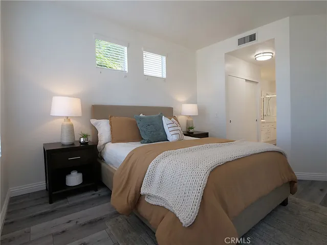 a bedroom with a bed and a lamp