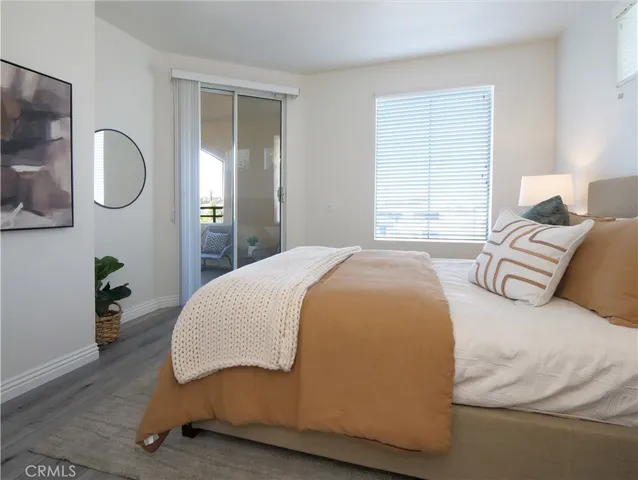 a spacious bedroom with a bed and dresser