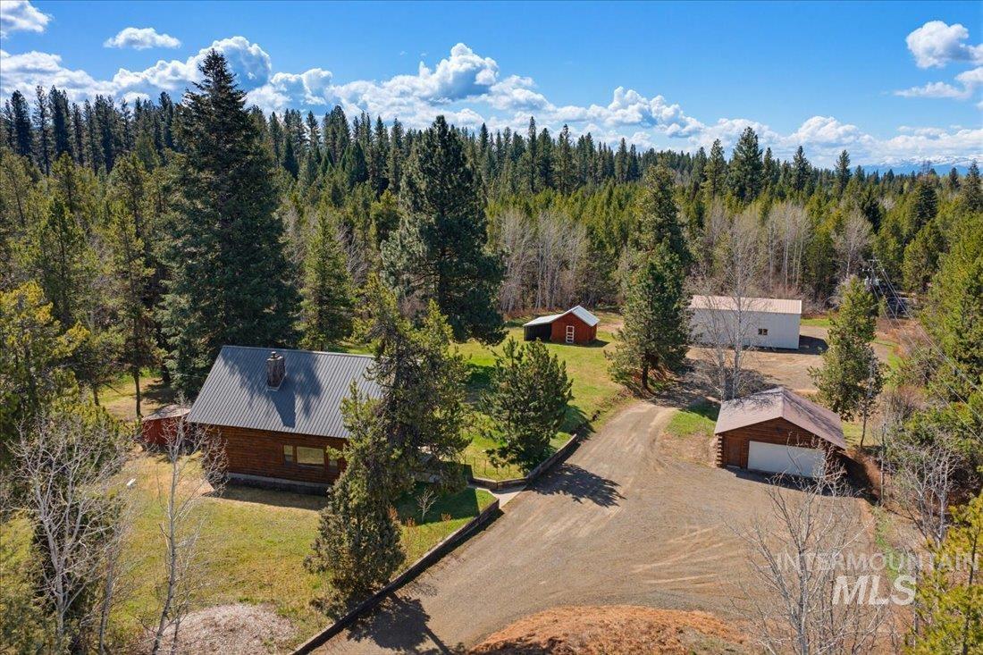 143 East Lk Frk Road McCall, ID 83638 - Photo 2 of 49 Expansive wooded property featuring a log home, a detached garage 2 car garage, 1584 sf steel building, sauna and an additional outbuilding.