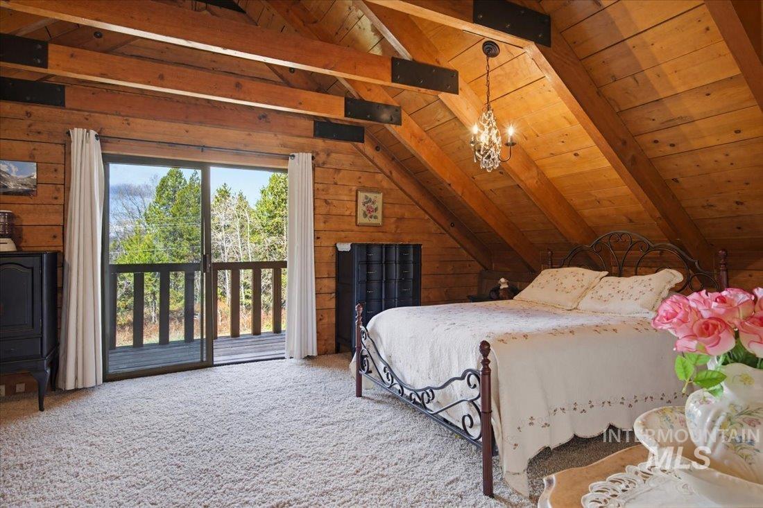 143 East Lk Frk Road McCall, ID 83638 - Photo 21 of 49 Vaulted wood ceiling with exposed beams with sliding doors to deck