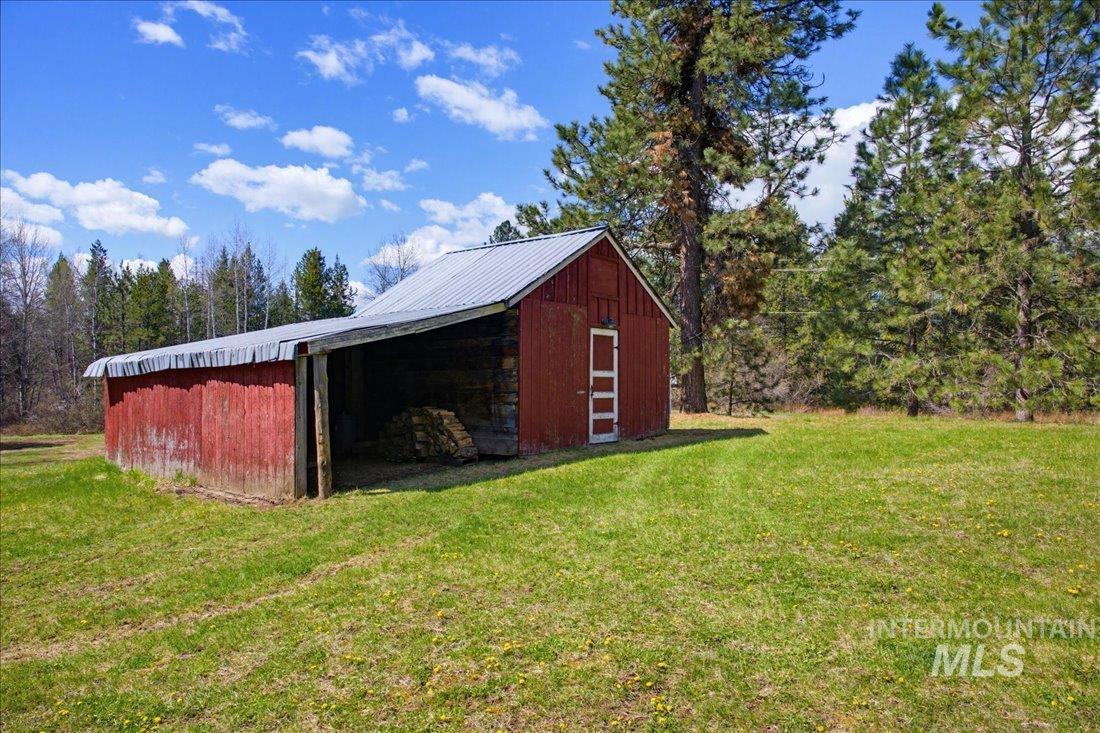 143 East Lk Frk Road McCall, ID 83638 - Photo 30 of 49 Red outbuilding with a metal roof and an open-sided storage area