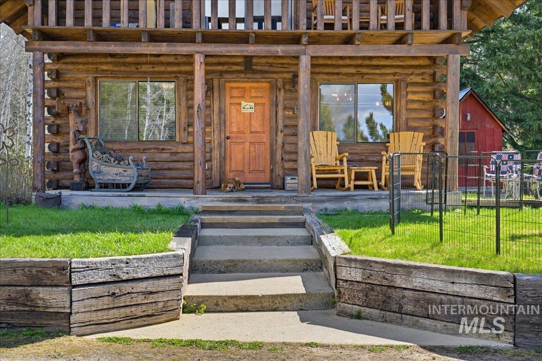 143 East Lk Frk Road McCall, ID 83638 - Photo 45 of 49 Rustic log cabin exterior featuring a covered front porch