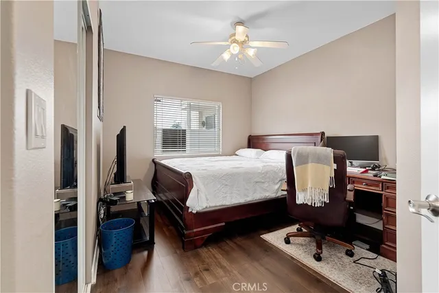 a bedroom with a bed tv and a window