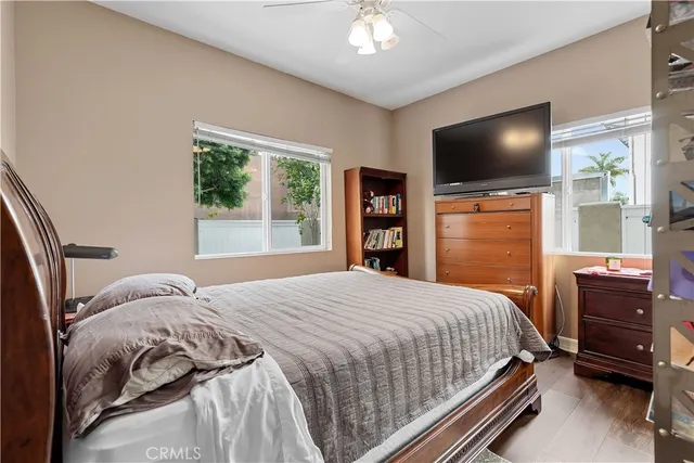 a bedroom with a bed and a flat tv screen on dresser