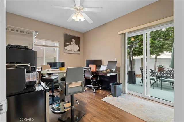 a view of a workspace with furniture and a window
