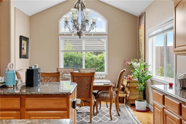 a dining room with furniture a window and a chandelier