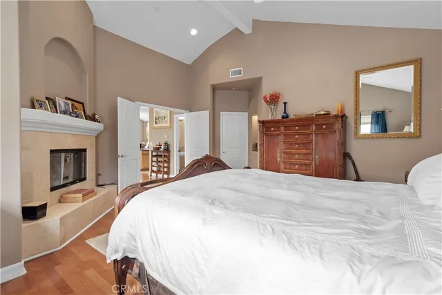 a bedroom with a bed and a fireplace