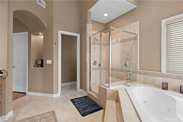 a bathroom with a tub a sink and a shower