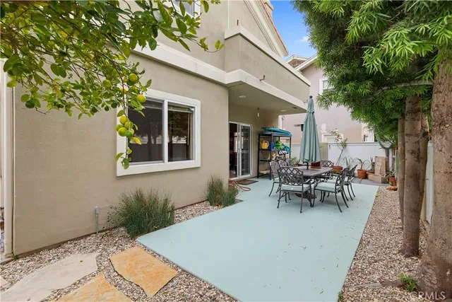 a view of a house with patio and a garden