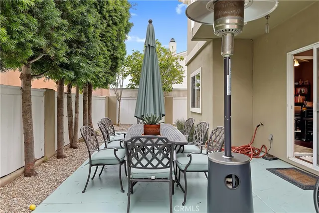 a view of a patio with table and chairs