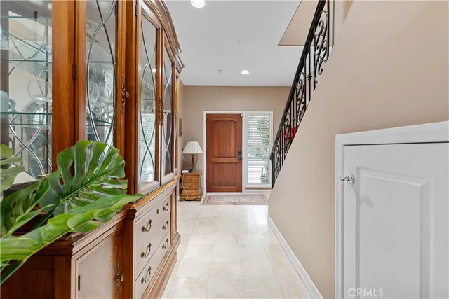 a view of entryway with wooden floor and stairs