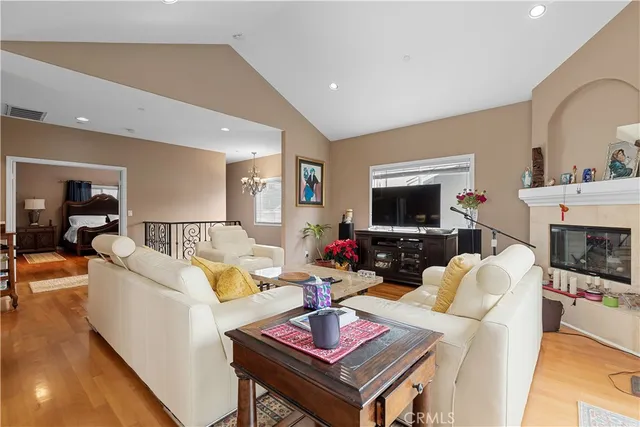a living room with furniture a flat screen tv and a fireplace