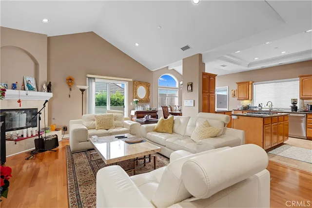 a living room with fireplace furniture and a large window