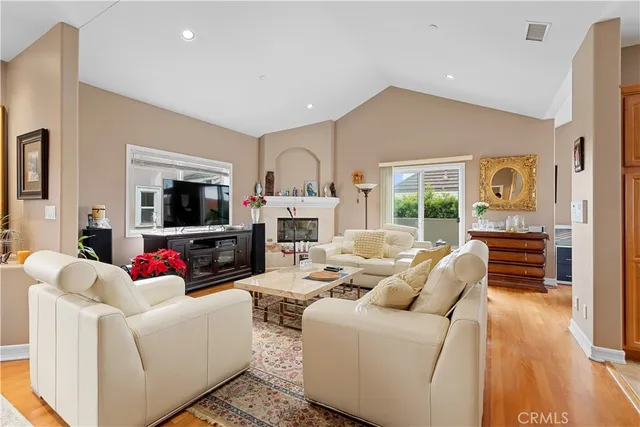 a living room with fireplace furniture and a flat screen tv