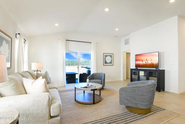 a living room with furniture and a lamp