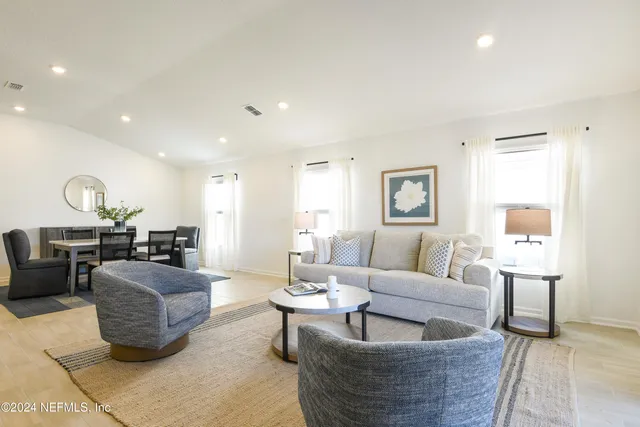 a spacious bedroom with a bed and a couch