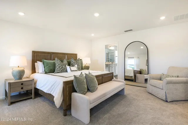 a spacious bedroom with a bed and furniture