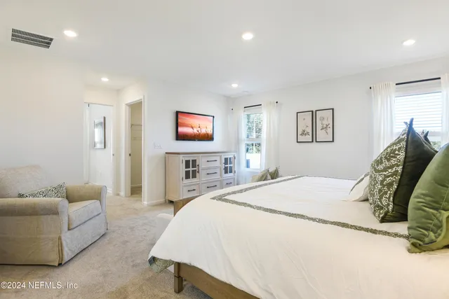 a spacious bathroom with double sink and a large mirror